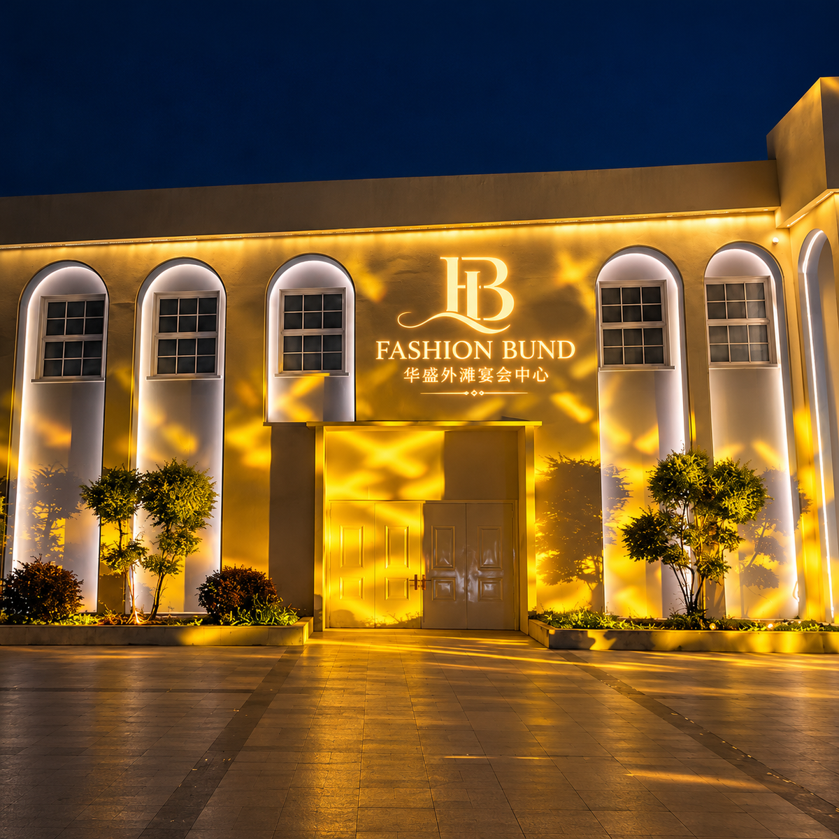 Building facade at night with Fashion Bund lettering and golden projected patterns around the entrance